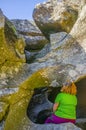 Trekker woman visiting spectacular granitic rock eroded by floods. Cornalvo Natural Park, Extremadura, Spain Royalty Free Stock Photo