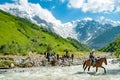 Trekkers crossing the Adishschala River in Georgia`s Svaneti region Royalty Free Stock Photo