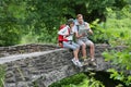 Trekkers relaxing on the stone bridge Royalty Free Stock Photo