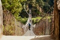 Trekkers and Sherpa crossing a suspension iron bridge in Everest base camp. Royalty Free Stock Photo