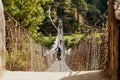 Trekkers and Sherpa crossing a suspension iron bridge in Everest base camp.