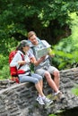 Trekkers taking break reading map in forest Royalty Free Stock Photo