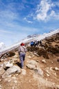 Trekkers walking uphill with blue sky