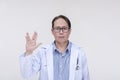 A trekkie fan and doctor makes the vulcan live long and prosper sign. Of asian descent, middle aged male in his 40s. Royalty Free Stock Photo