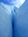 Glacier crack background under blue sky. Trekking, adventure and extreme nature Royalty Free Stock Photo