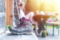 Trekking boots on the veranda of an alpine hut. Summer holidays in the mountains