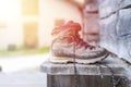 Trekking boots on the veranda of an alpine hut. Summer holidays in the mountains