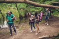 Trekking, camping and wild life concept. Four best friends are hiking in the spring woods, ladies are talking and laughing, all ar Royalty Free Stock Photo