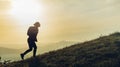 Trekking In Mountains. Tourist With Backpack Goes Up Mountain Road Royalty Free Stock Photo