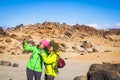 Trekking and outdoor mountain excursion people activity with two women adult friends taking selfie picture together having fun