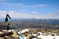 Trekking poles on a snowy summit of a mountain with a great view