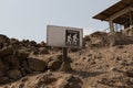 Trekking sign on top of a rocky and deserted mountain surface Royalty Free Stock Photo