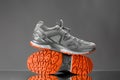 Trekking sneakers with red sole, gray background Royalty Free Stock Photo