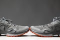 Trekking sneakers with red sole, gray background with copy-space Royalty Free Stock Photo