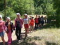 Trekking teenagers in the woods, children`s summer camp.