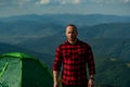 Trekking, travel and tourism concept. Casual man on camping, traveler life style. Young guy standing alone on outdoor Royalty Free Stock Photo