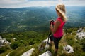 Trekking - woman hiking in mountains on a calm sumer day