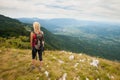 Trekking - woman hiking in mountains on a calm sumer day