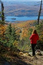 Young woman admires landscape during fall season from Mont Tremblant