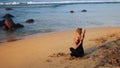 Tremendous lady in black tracksuit sits in yoga pose