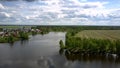 Tremendous winding river reflects green trees silhouettes