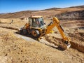 Trench excavation process with excavator for water channel construction Royalty Free Stock Photo