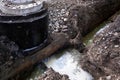 Trench filled with water, replacement of pipes and communications. The work of utilities to replace the water supply system in the Royalty Free Stock Photo