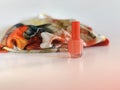 Trend of the actual colors for season 2019 - Living Coral. nail bottle and fashionable neckerchief on white background