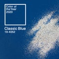 Silver sparkles and glitter on a classic blue background. Color of the year 2020