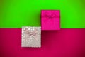 Plastic pink and silver gift boxes on a trend color background