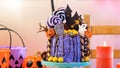 On trend Halloween candyland novelty drip cake in colourful party setting. Royalty Free Stock Photo