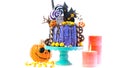 On trend Halloween candyland novelty drip cake on white background.