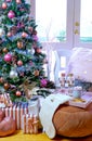 On trend pink and rose gold trimmed Christmas tree with tray for Santa. Royalty Free Stock Photo