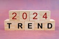 The 2024 TREND text on wooden cubes. Business and New Year concepts