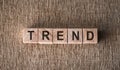 Trend word on wooden blocks on brown background