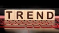 Trend word on wooden cubes on illuminated laptop keyboard. Popular and relevant topics. Royalty Free Stock Photo