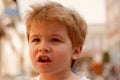 Trendiest haircut. Little child eating outdoor. Small boy with stylish haircut. Little child with short blond hair