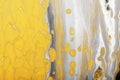 Trending colors of 2021. Flow of gray paint with yellow bubbles drops. Marble effect background or texture. Fluid Art