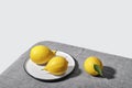 Trending colors of 2021. Yellow illuminating lemons on Ultimate gray tablecloth. Isometric view minimal still life