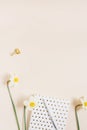 Trending minimalistic flat design of a blogger\'s workplace. Notepad, pen and bouquet of daffodils