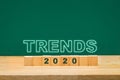 Trends 2020 idea on wood cube block on table with green blackboard.business forecasting concept Royalty Free Stock Photo