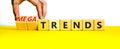 Trends or megatrends symbol. Businessman turns cubes and changes words trends to megatrends. Beautiful yellow table, white