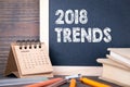 2018 trends. paper calendar and chalkboard on a wooden table Royalty Free Stock Photo