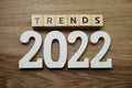 Trends 2022 word alphabet letters on wooden background Royalty Free Stock Photo