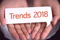 Trends 2018 wording on white talk bubble with hand. Royalty Free Stock Photo