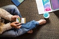 Trendy adult woman sit on the floor and work ot chat with technology devices as phone and laptop computer -unrecognizable girl use