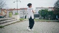 African girl performing dance on town paving. Woman choreographer moving body Royalty Free Stock Photo