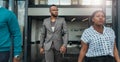 Trendy african business man walking out confidently with colleagues Royalty Free Stock Photo