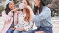 Trendy asian girls having fun together outdoor - Young women friends playing with bubble gum - Trends, youth, millennial Royalty Free Stock Photo