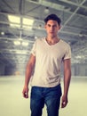 Trendy attractive young man standing in empty warehouse Royalty Free Stock Photo